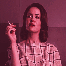 Lana Winters holds a cigarette in American Horror Story